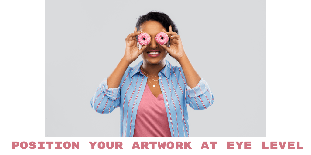 woman holding up doughnuts to eyes in blue shirt with pink top, position artwork at eye level text