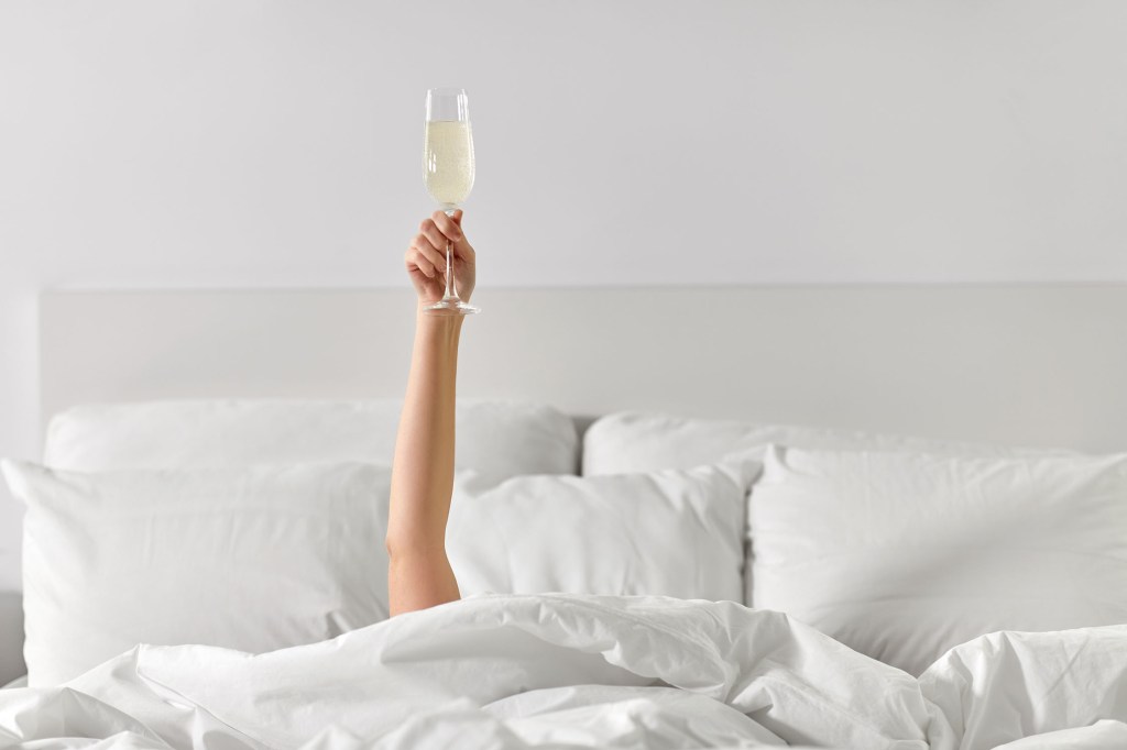 celebration champagne in bed after selling work from online art show