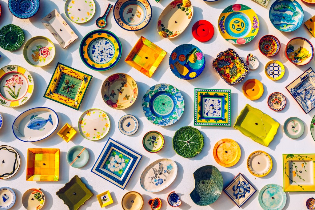 a selection of ceramics in bright colours that function as artwork and home decor in a kitchen