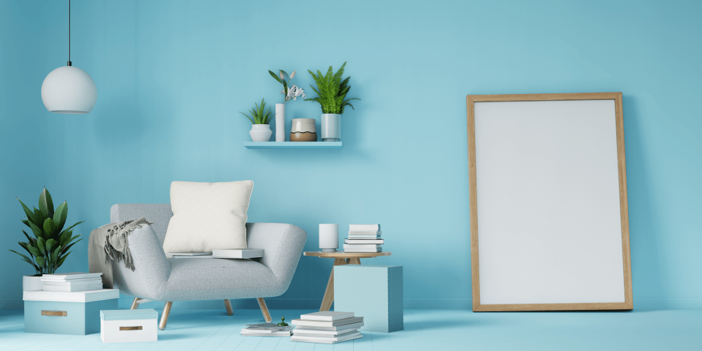 A light blue room with stylish chair and leant up frame against wall to show artwork home decor