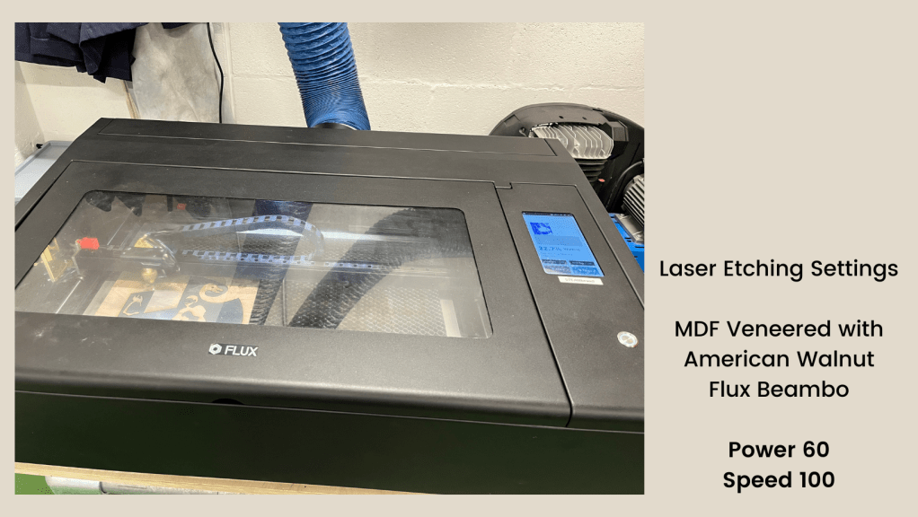 laser beambo box cutter with silver acrylic and wood grain sheets waiting for engraving, design shown is 'the last sheep' by artist charlie kirkham