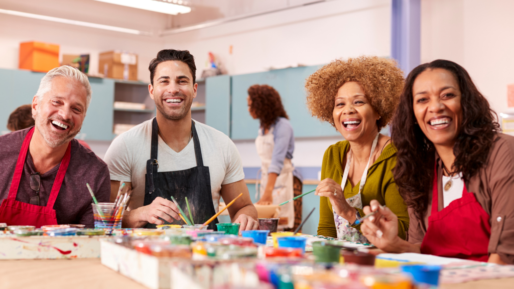 group of people in art class having fun and smiling