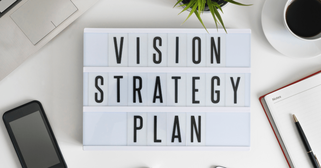 desk with vision strategy plan written on it